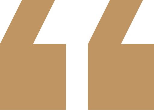 Golden quotes symbol on dark backdrop.