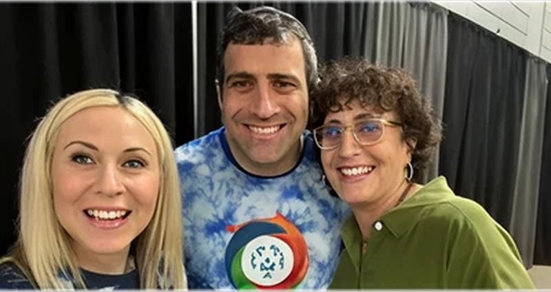 Three people smiling at the camera