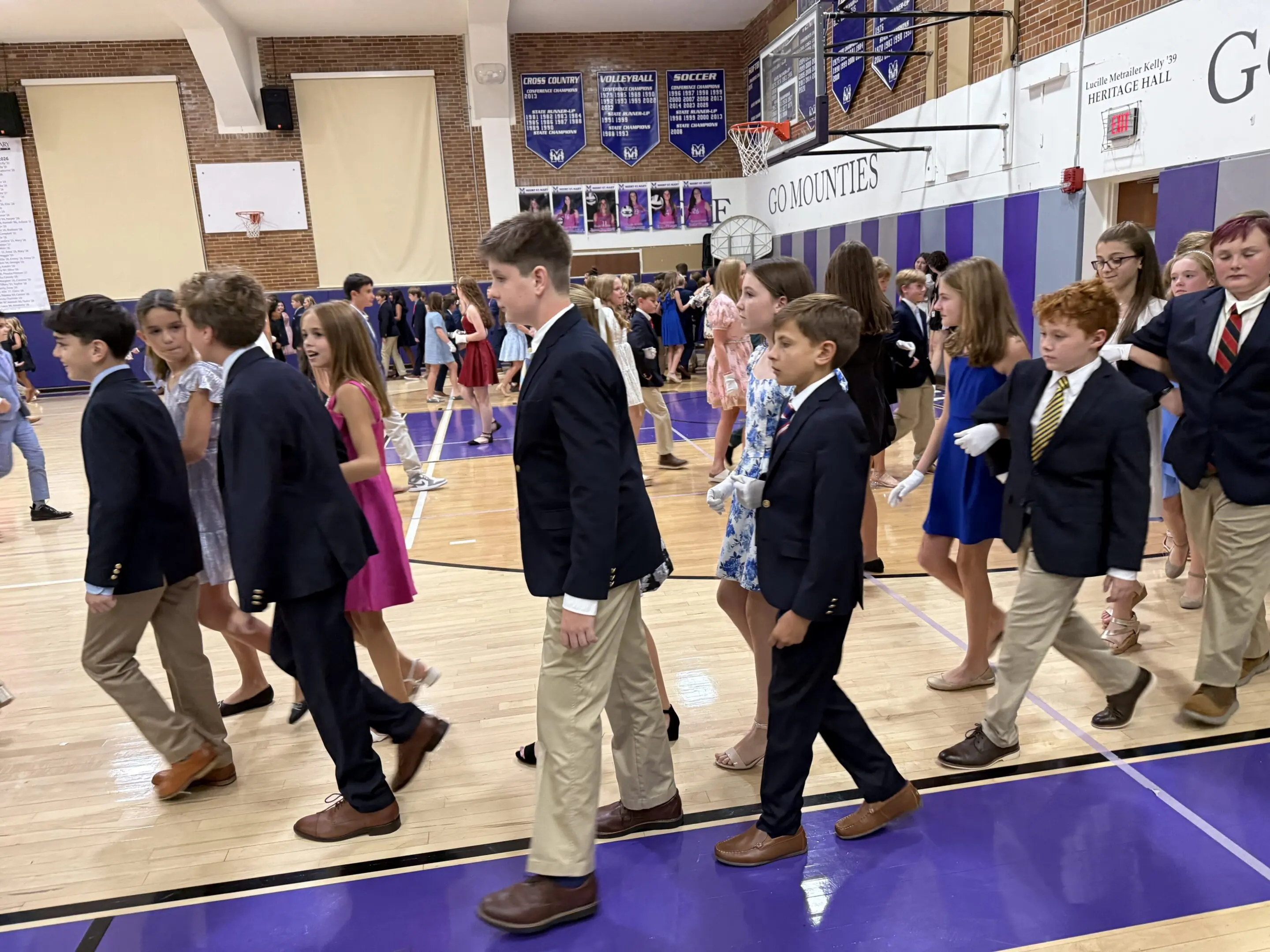 Little Rock Junior Cotillion students in formal attire practicing movement and social skills